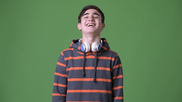 Young Handsome Iranian Teenage Boy Against Green Background