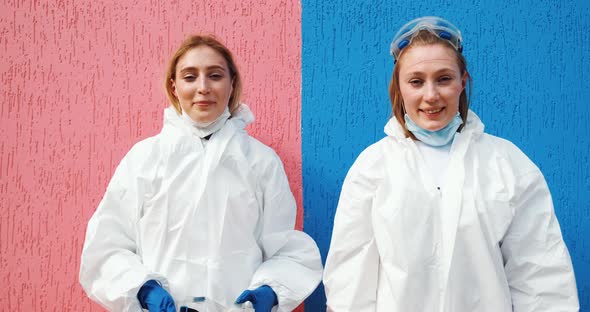 Girls twins work as doctors epidemiologists fighting with coronavirus pandemic. Disinfection workers