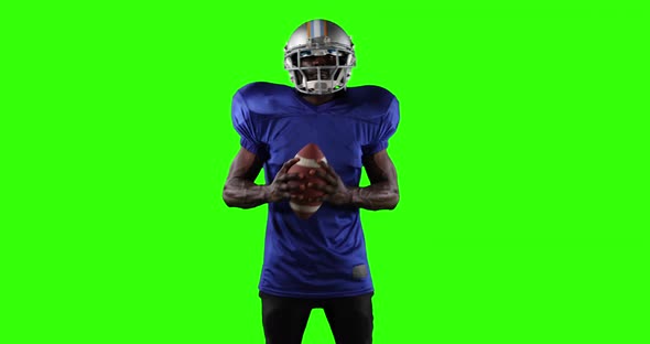 African American football player on green screen background.