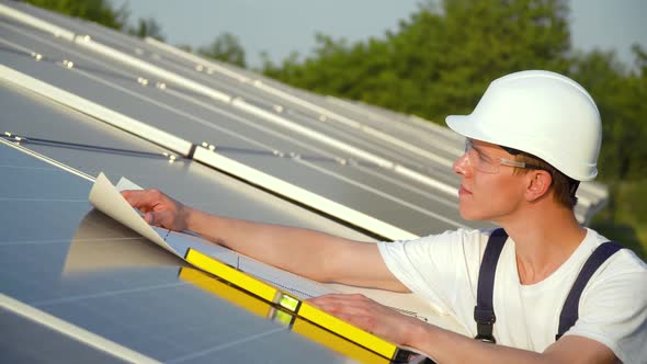 Solar Panel Technician Working with Solar Panels. The Green Energy Concept