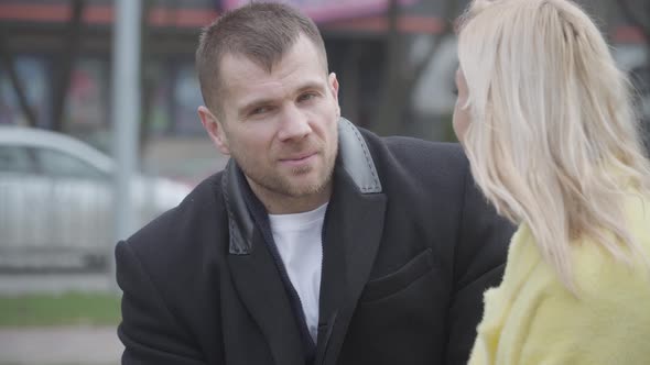 Elegant Caucasian Man Talking To Beautiful Blond Woman and Smiling