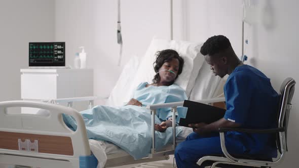 A Young AfricanAmerican Male Doctor is Talking to a Patient