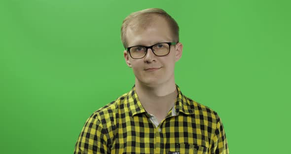 Young Man in Yellow Shirt Turning His Head and Looking in the Camera