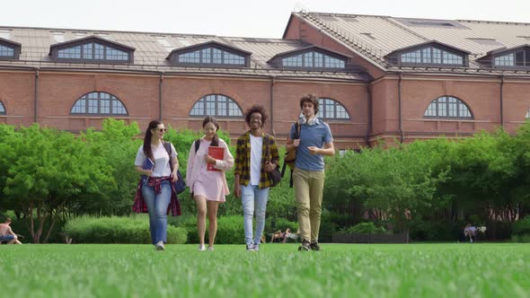 Full Length View of Group of Students Walking Together in Park