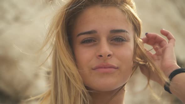 Close Up Portrait of Young Woman with Blond Hair in the Wind