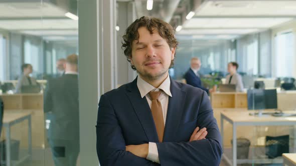 Portrait of Confident Businessman with Arms Crossed in Office