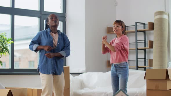 Women with Boxes Moving in New Home and Dancing