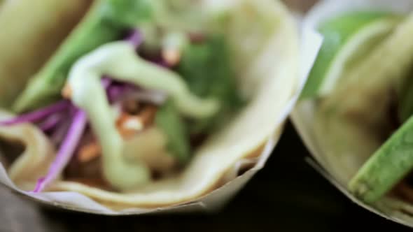 Street fish tacos with cod in recycled paper food tray.