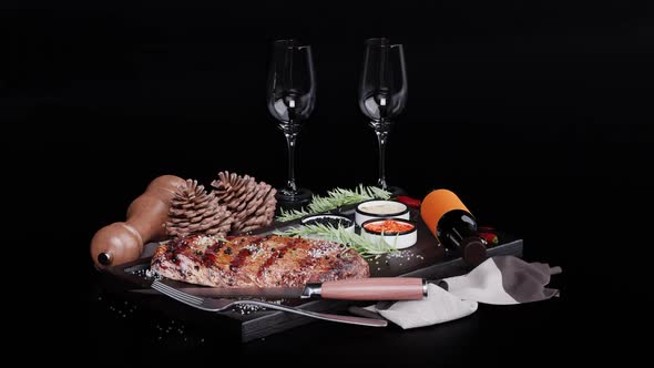Festive table on a dark background: steak and glasses