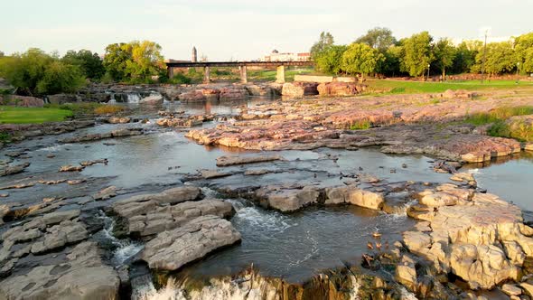 Aerial view over Falls Park in Sioux Falls, South Dakota. Ducks swimming in the calmer waters.