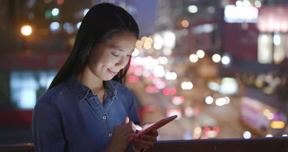 Woman use of mobile phone over traffic background