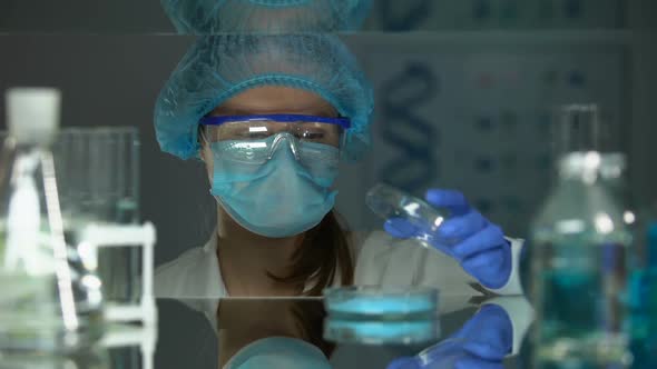 Researcher Analyzing Blue Pigment With Magnifying Glass, Dye-Staff Powder