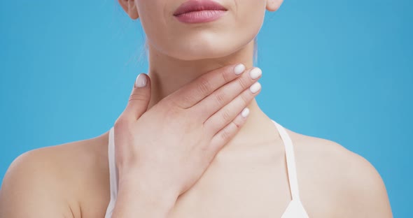 Young Unrecognizable Woman Suffering From Sore Throat Touching Her Neck Blue Background Close Up