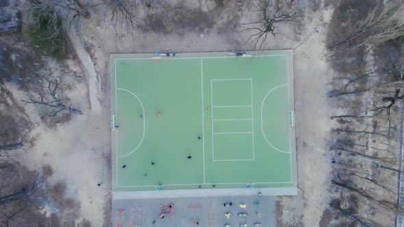 People play soccer. Football game on field, top down view. Football match play