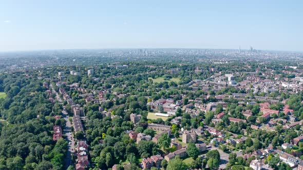 Dolly forward drone shot over green spaces south London