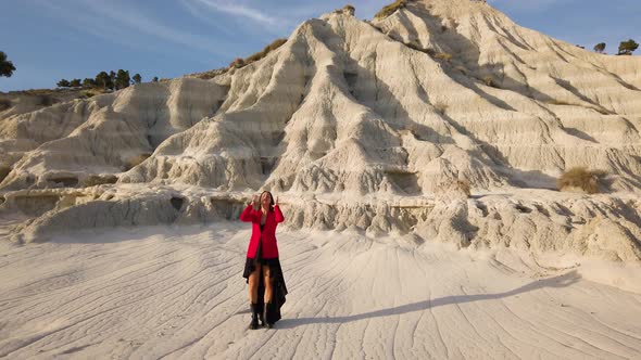 Beautiful girl with Red Dress on the Badlands