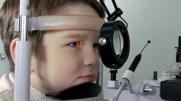 Optometrist Performing Visual Field Test of Young Boy