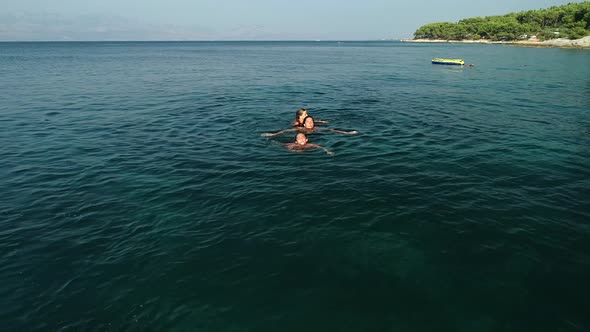 Tracking shot of family swimming in Adriatic sea.