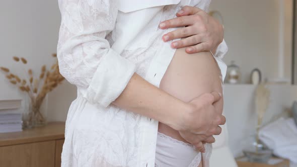 Pregnancy And Maternity Concept. Belly Of A Pregnant Woman