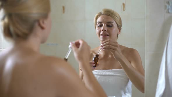 Cute Lady Applies Face Moisturizer on Dry Sensitive Skin, Cosmetology at Home