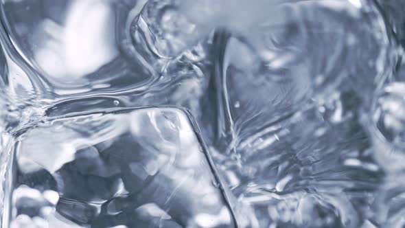 Super Slow Motion Detail Shot of Pouring Alcohol Liquid on Ice Cubes at 1000 Fps