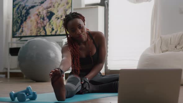 Woman with Black Skin Doing Workout in Living Room Stretching Exercise