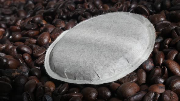 Paper coffee pod and roasted beans 4K slow pan footage