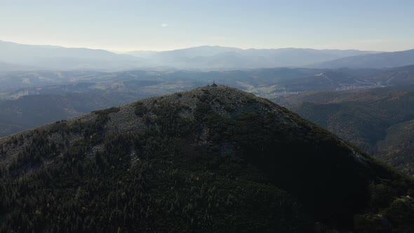 Aerial Landscape View of High Peaks with Dark Pine Forest Trees in Wild Mountains