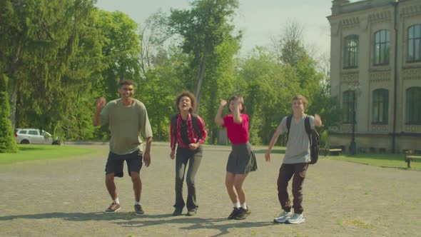 Joyful Carefree Diverse Multiracial University Students Jumping Outdoors