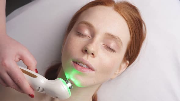 Attractive Redhaired Woman on a Cosmetology Procedure in a Beauty Salon