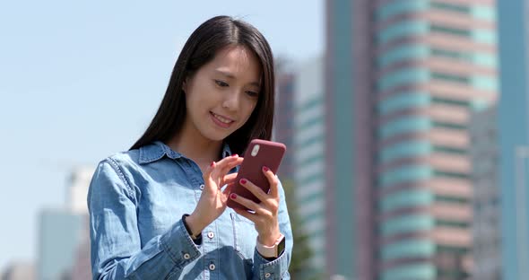 Young woman use of mobile phone in city