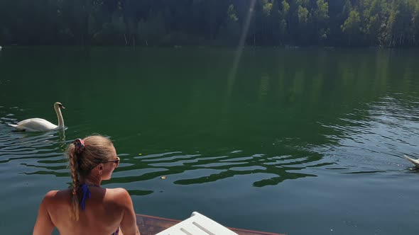 Woman Sit on a Sunbed in Sunglasses and Swimming Suit