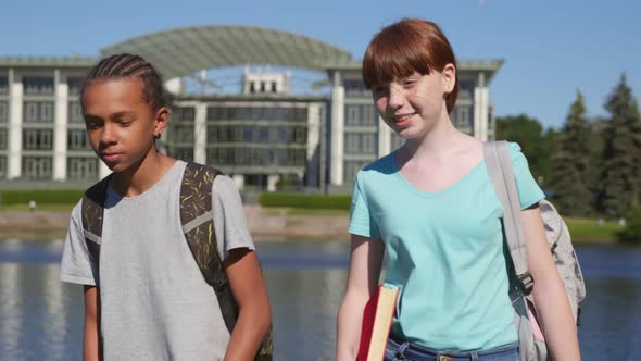 Diverse Teenage Kids with Backpack and Book Walking in Park After School