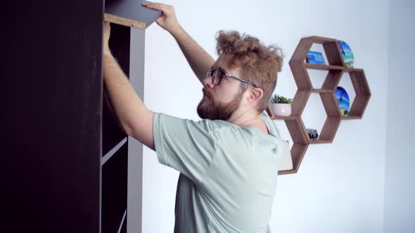 Bearded Man Assembling New Furniture at Home