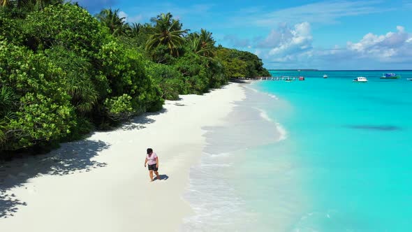 Girl sunbathing on exotic coast beach journey by shallow water with clean sandy background of the Ma