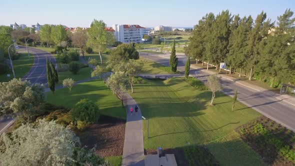 Aerial View Running Woman with Middle Aged Fitness Trainer in Park on Asphalt Track