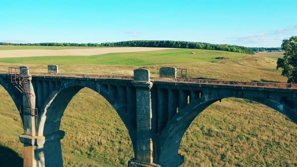 Lady Athlete Is Walking Along a Massive Stone Bridge. Tourist, Travel, Adventure Concept