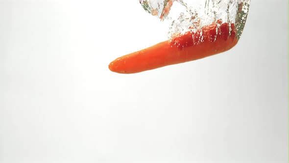 Super Slow Motion One Carrot Falls Under the Water with Air Bubbles