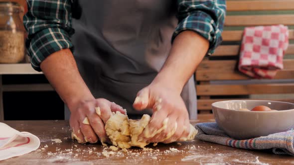 Hands Kneading Raw Dough on Table Flat Lay. Top View on Baker with Empanadas Cooking on Table