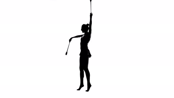 Gymnast Standing on One Leg and Holds a Mace in His Hand. White Background. Silhouette