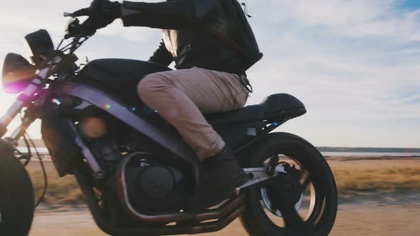 Motorcyclist Driving His Motorbike on the Road During Sunset Slow Motion