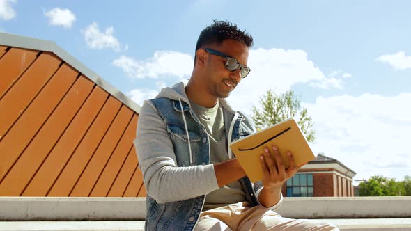 Indian Man with Notebook or Sketchbook on Roof Top