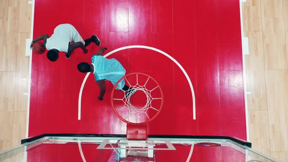 Two African Sportsmen are Throwing a Basketball in a Top View