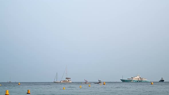 Mediterranean sea coast with floating yachts and boats at sunset in Cannes