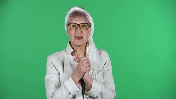 Portrait of Old Stylish Woman Is Looking at the Camera with Excitement, Then Celebrating Her Victory