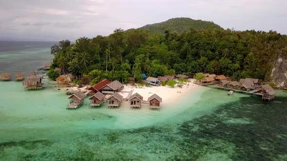 Resort with overwater bungalows in the Raja Ampat island chain in Indonesia , Aerial circle around s