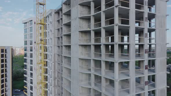 Aerial view of high residential apartment building under construction. Real estate development.