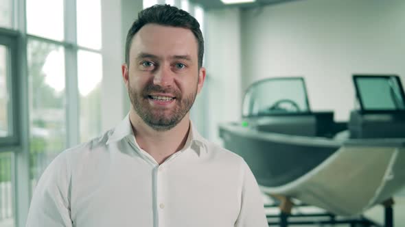 Salesman of Boats Smiling in the Showroom