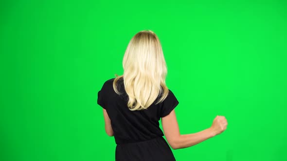 Cheerful Girl Walking, Dancing and Singing. Chroma Key. Slow Motion. Back View.