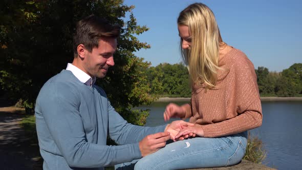 A Man Proposes To His Girlfriend in a Park